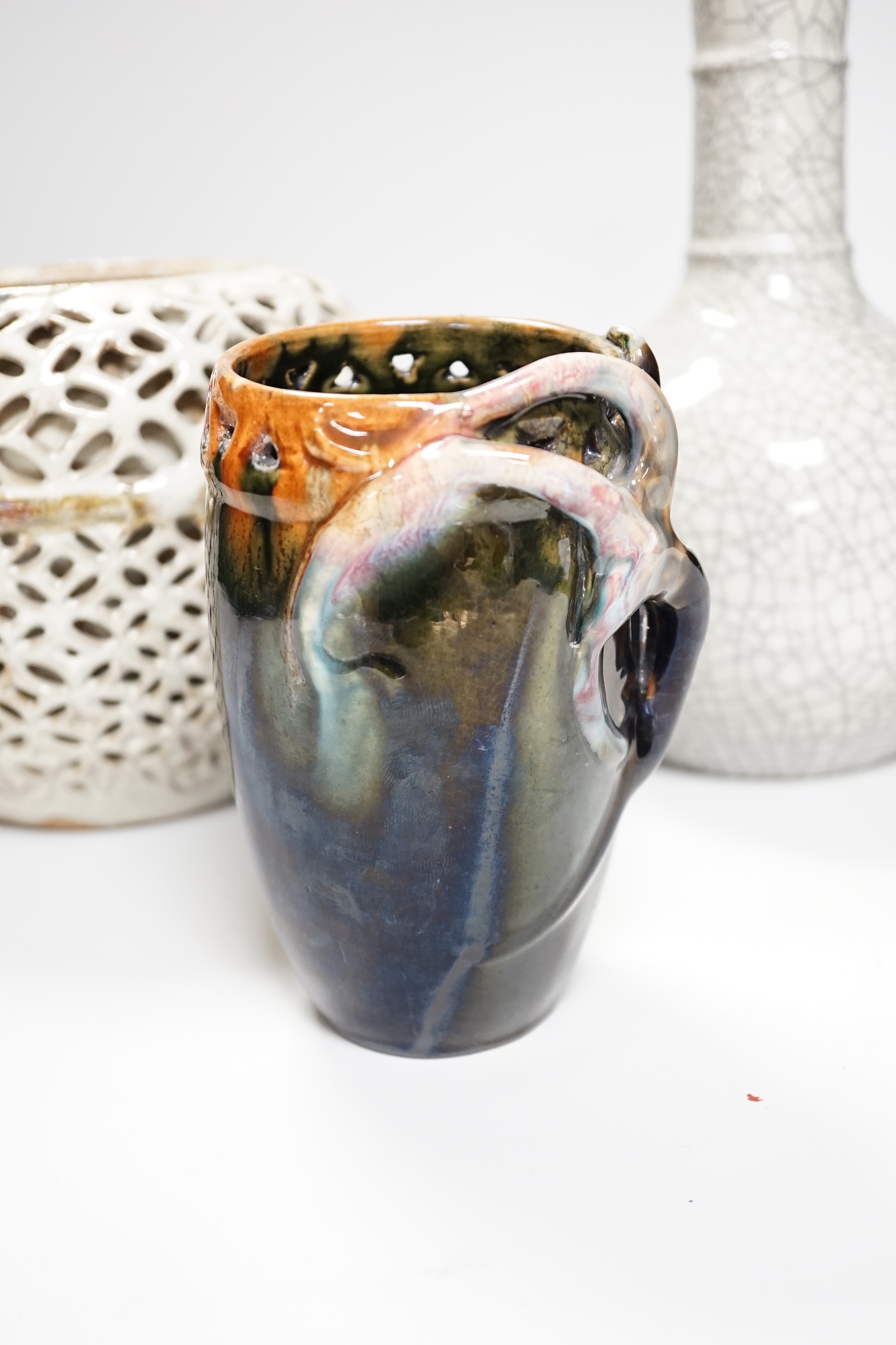 A Chinese crackle glaze bottle vase, a reticulated pottery vase and pottery vase, tallest 23cm high